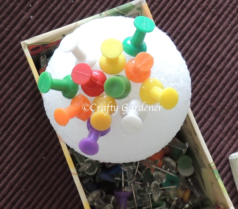 a plant poke made from a styrofoam ball and push pins at craftygardener.ca