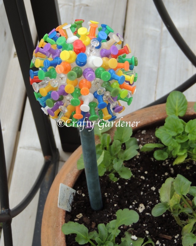 a plant poke made from a styrofoam ball and push pins at craftygardener.ca